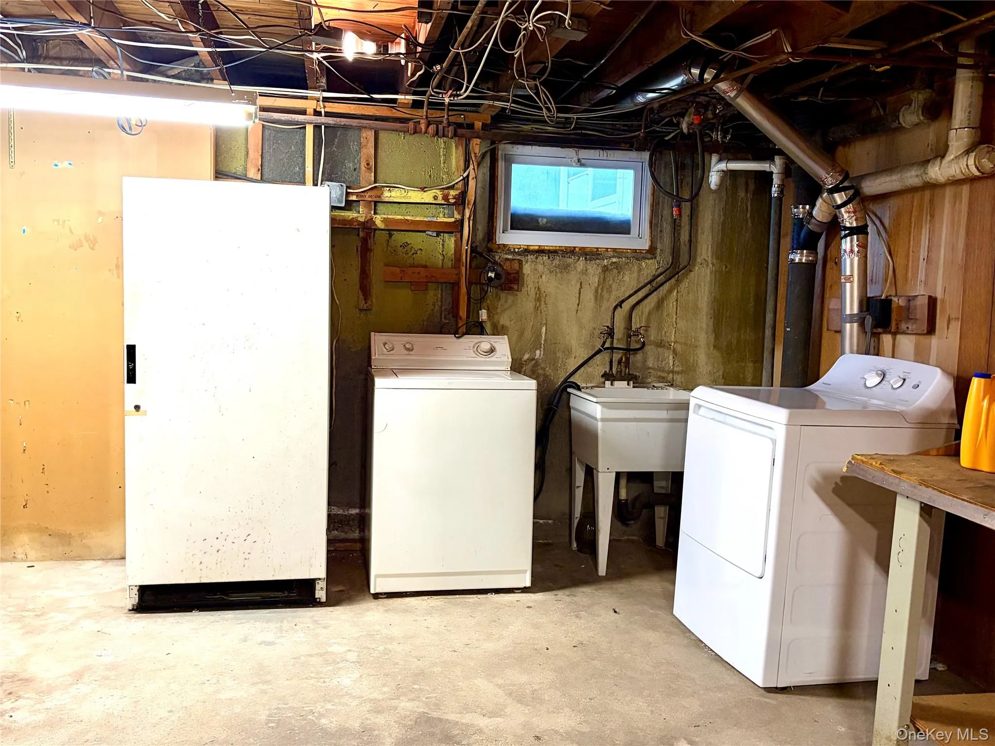 Basement With Laundry Area And Additional Refirgerator Basement With Laundry Area And Additional Refirgerator