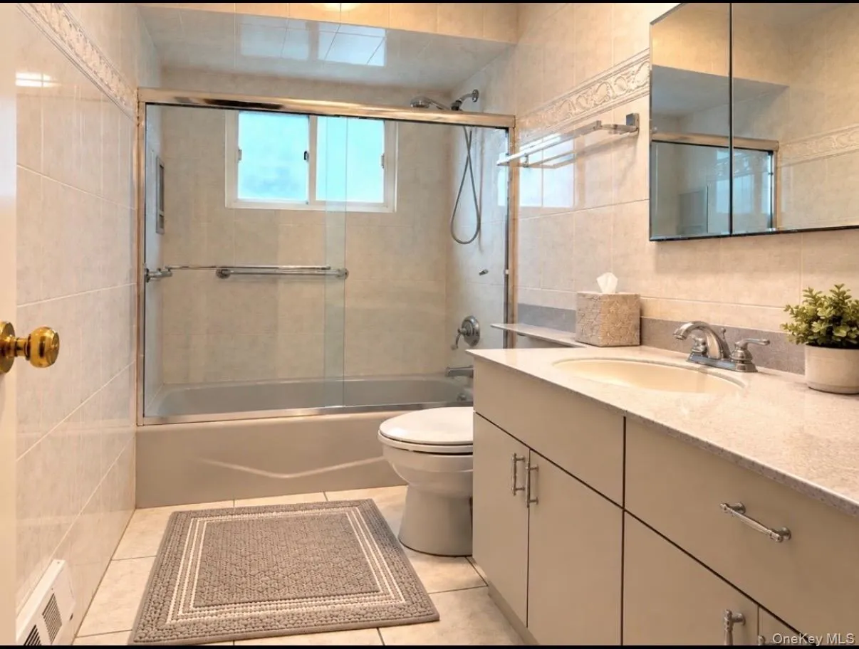 Full Bath Main Level. True Color in person is Neutral Gray Tones Full Bath Main Level. True Color in person is Neutral Gray Tones