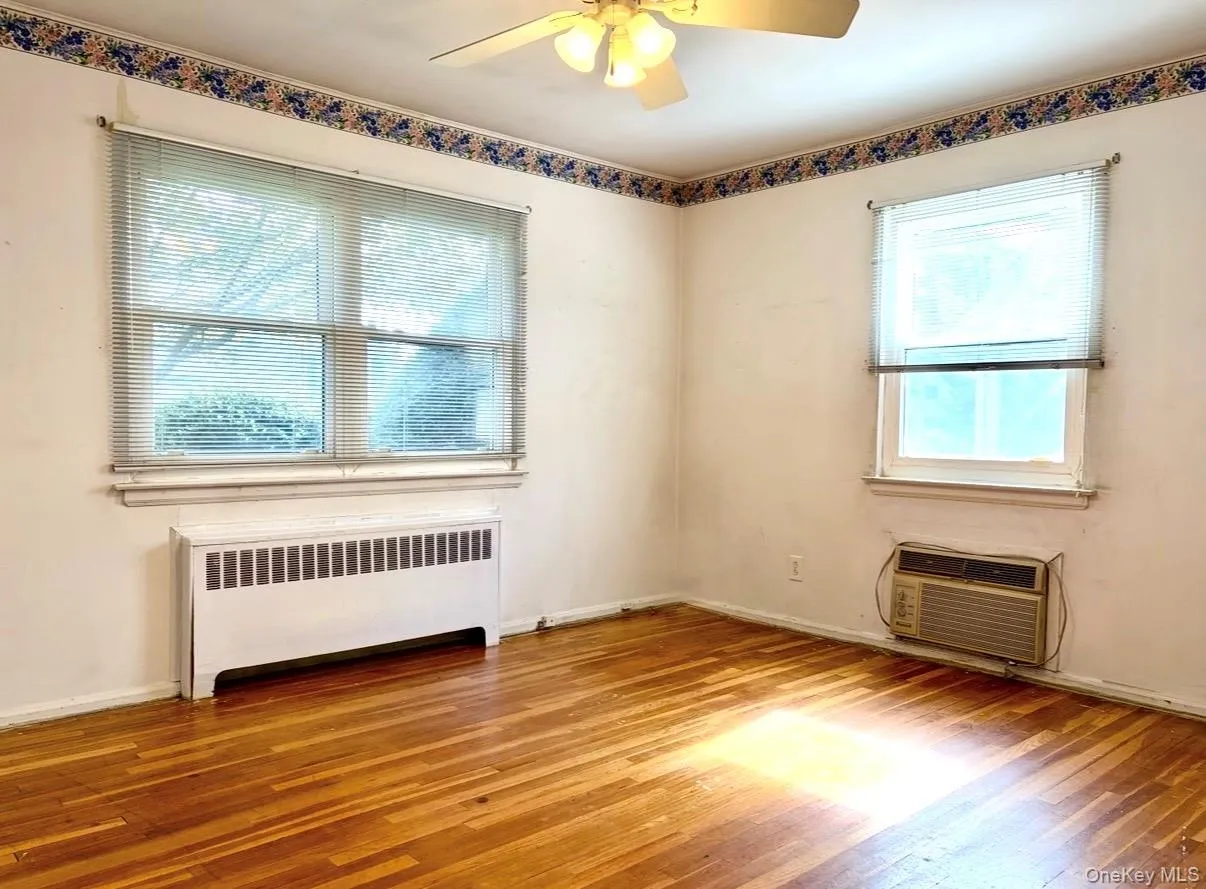 Primary Bedroom With Hardwood Flooring Primary Bedroom With Hardwood Flooring