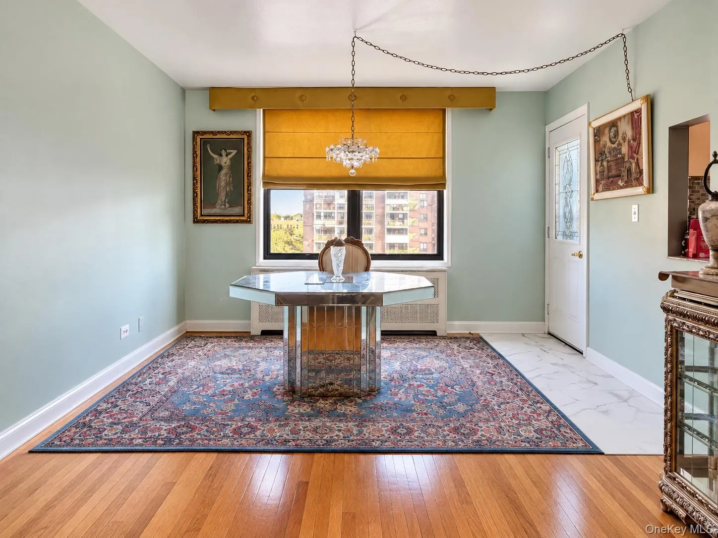 Hardwood flooring, crystal chandelier, and exterior door with decorative glass insert Hardwood flooring, crystal chandelier, and exterior door with decorative glass insert