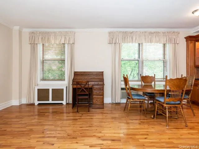 Hardwood flooring, crown molding, and a custom decorative radiator cover Hardwood flooring, crown molding, and a custom decorative radiator cover
