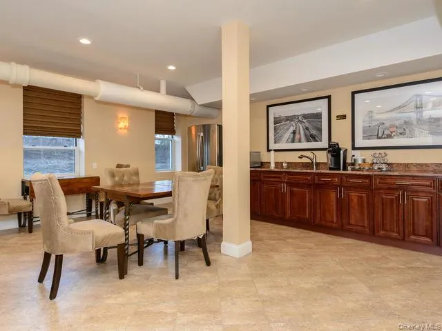 Common room with custom cabinetry with stone countertops, integrated sink, recessed lighting, and tile flooring Common room with custom cabinetry with stone countertops, integrated sink, recessed lighting, and tile flooring
