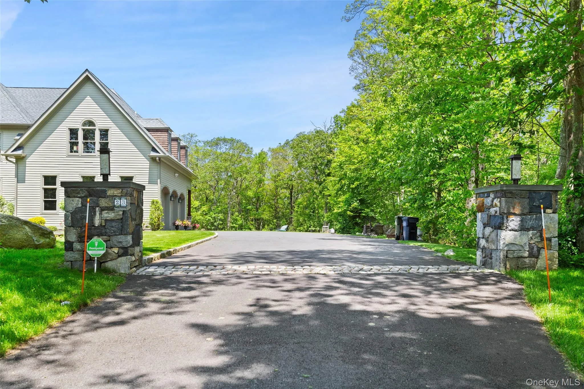 View of stone pillars and expansive driveway View of stone pillars and expansive driveway
