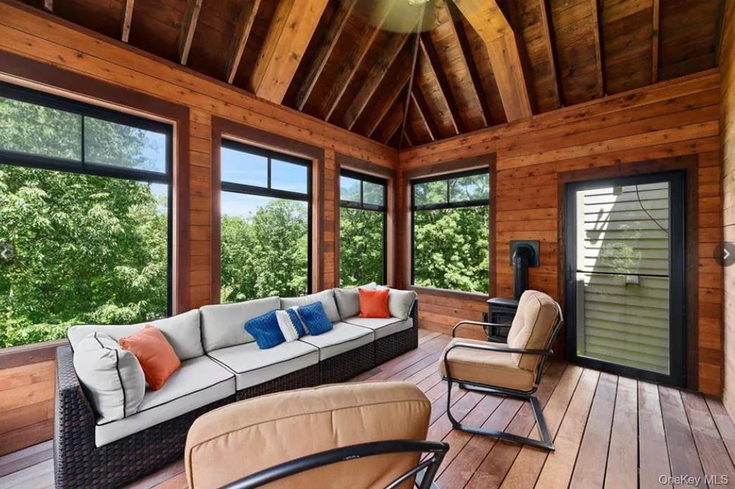 Sunroom with outdoor lounge area and lofted ceiling Sunroom with outdoor lounge area and lofted ceiling