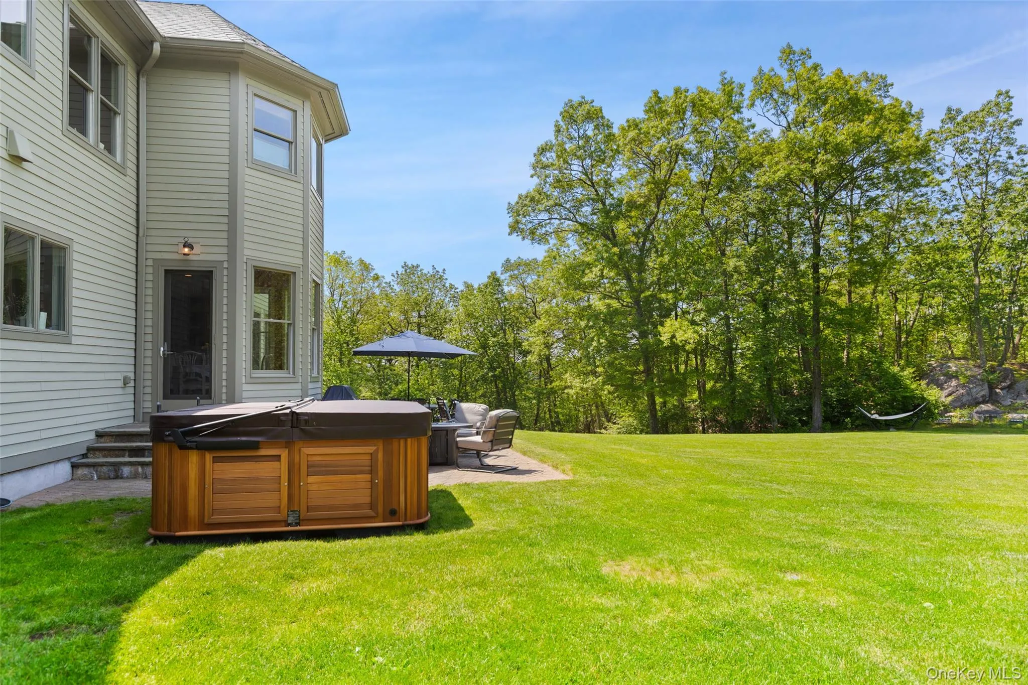 View of grassy yard featuring a hot tub View of grassy yard featuring a hot tub