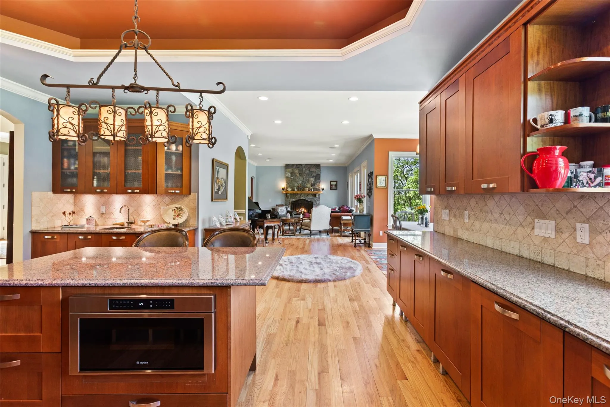 Kitchen featuring ornamental molding, arched walkways, light wood-style floors, recessed lighting, and open shelves Kitchen featuring ornamental molding, arched walkways, light wood-style floors, recessed lighting, and open shelves