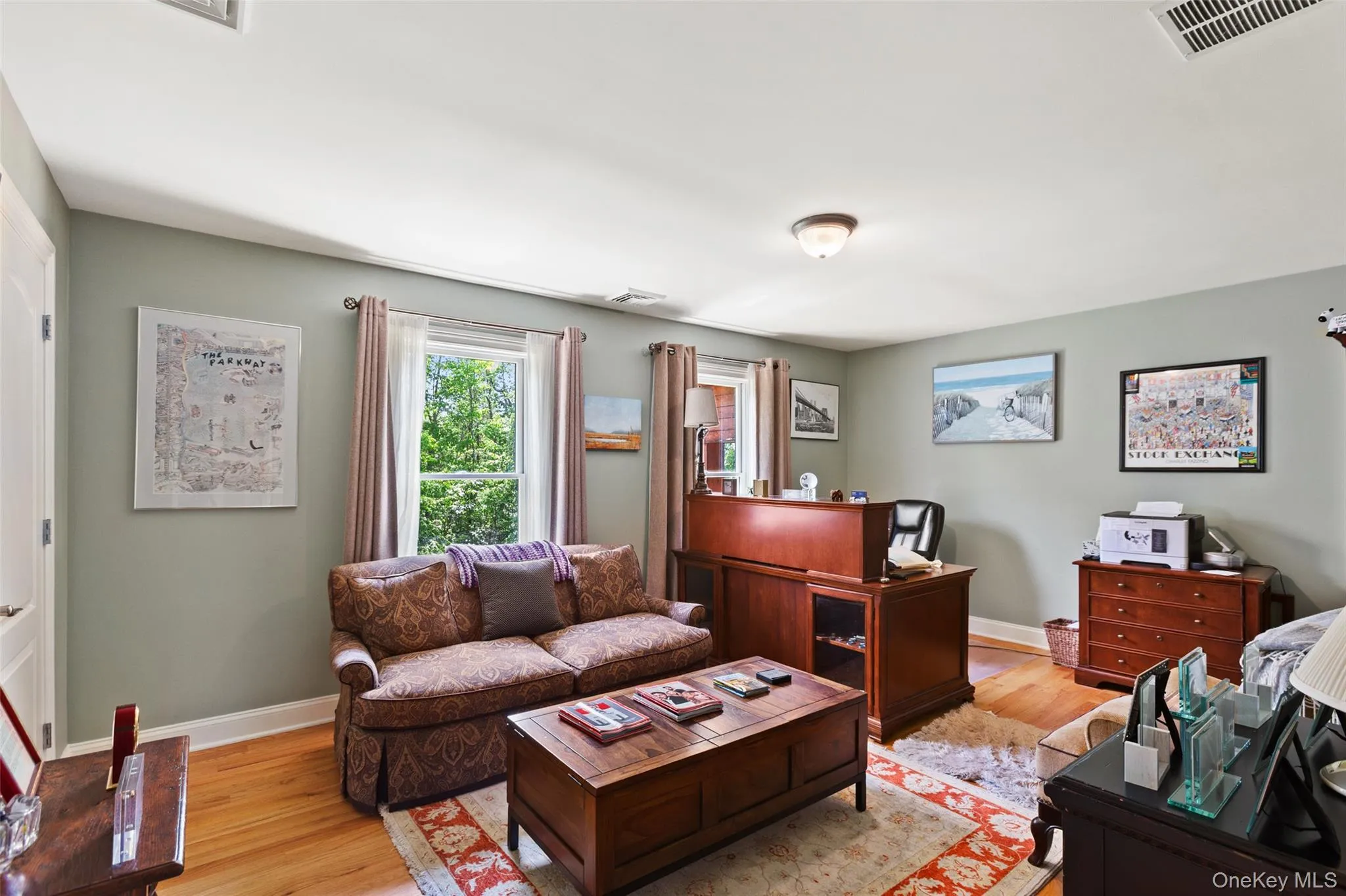 Living room with light wood-style flooring, baseboards, and an office area Living room with light wood-style flooring, baseboards, and an office area