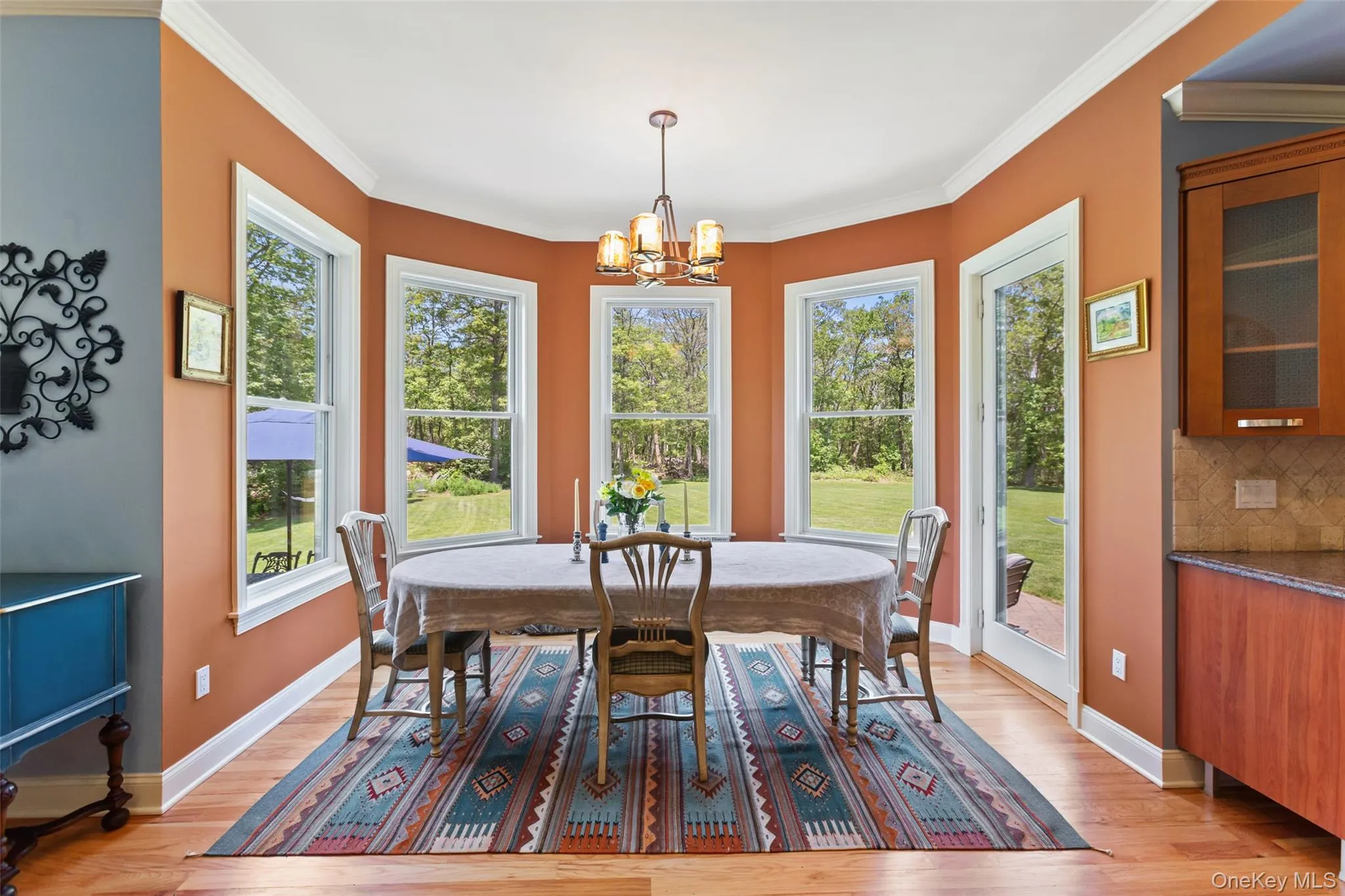 Dining area featuring plenty of natural light, a chandelier, light wood-style flooring, and crown molding Dining area featuring plenty of natural light, a chandelier, light wood-style flooring, and crown molding