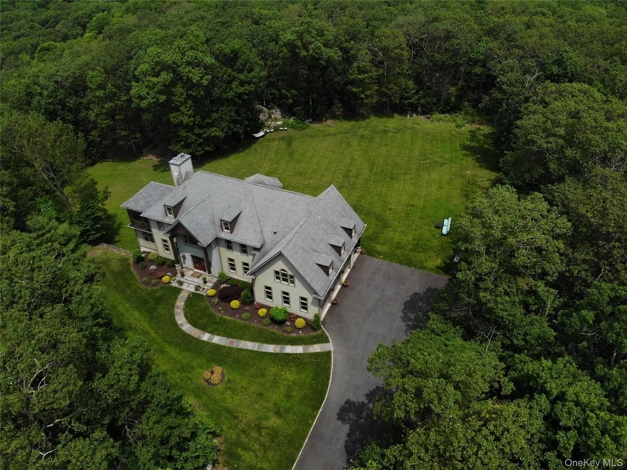 Aerial view of property and surrounding area with a heavily wooded area Aerial view of property and surrounding area with a heavily wooded area