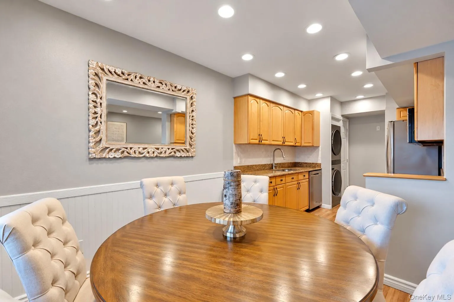 Beadboard wainscoting, recessed lighting, wood-finish cabinetry, stone countertops, and built-in laundry appliances Beadboard wainscoting, recessed lighting, wood-finish cabinetry, stone countertops, and built-in laundry appliances