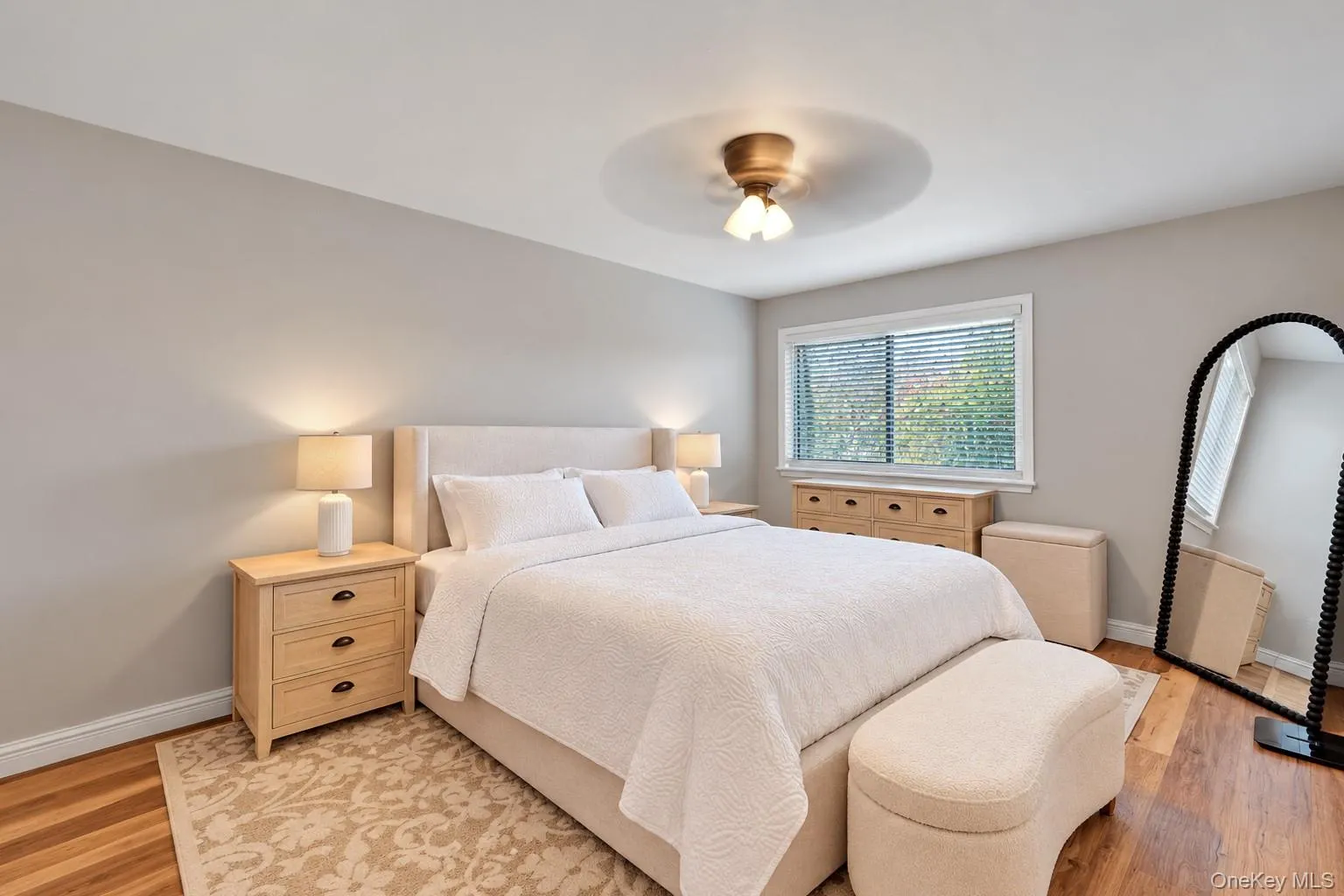 Neutral wall color, wood-finish flooring, and a central ceiling fan with integrated lighting Neutral wall color, wood-finish flooring, and a central ceiling fan with integrated lighting