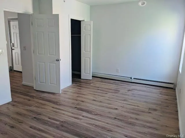 Huge Bedroom with hardwood floors and plenty of Sunlight Huge Bedroom with hardwood floors and plenty of Sunlight