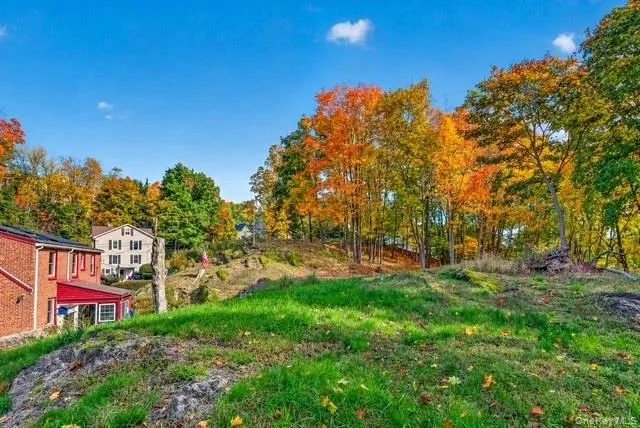 Expansive outdoor lot featuring natural rock outcroppings, mature hardwood trees, and open green space Expansive outdoor lot featuring natural rock outcroppings, mature hardwood trees, and open green space