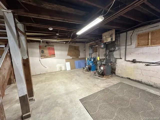 Unfinished below grade area featuring a heating unit Unfinished below grade area featuring a heating unit