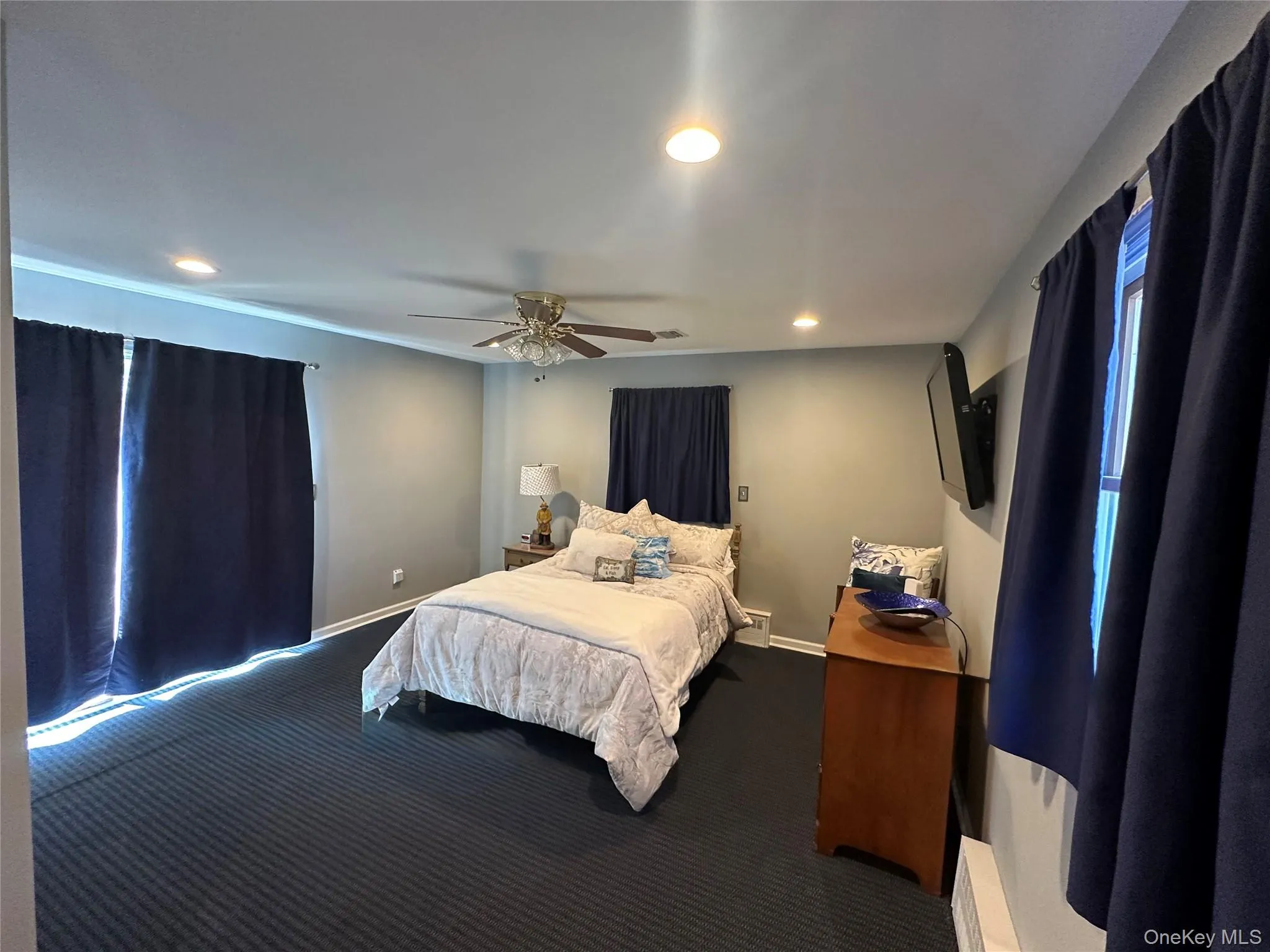 Spacious room featuring recessed lighting, a ceiling fan, and wall-to-wall carpeting Spacious room featuring recessed lighting, a ceiling fan, and wall-to-wall carpeting