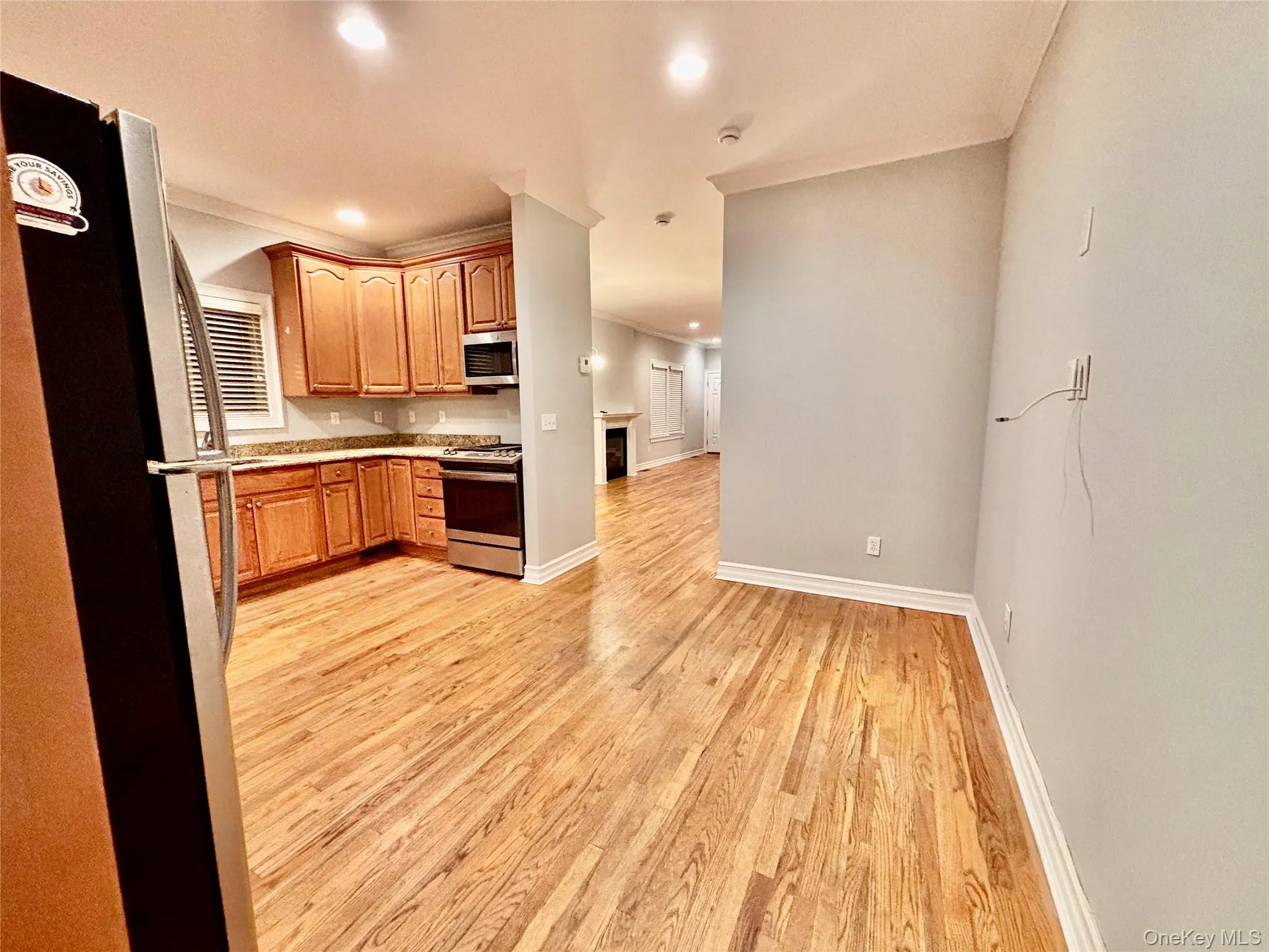 Kitchen featuring appliances with stainless steel finishes, light countertops, recessed lighting, light wood-style flooring, and open floor plan Kitchen featuring appliances with stainless steel finishes, light countertops, recessed lighting, light wood-style flooring, and open floor plan
