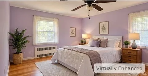 Hardwood flooring, dual windows with natural lighting, and a ceiling fan with integrated light fixture Hardwood flooring, dual windows with natural lighting, and a ceiling fan with integrated light fixture