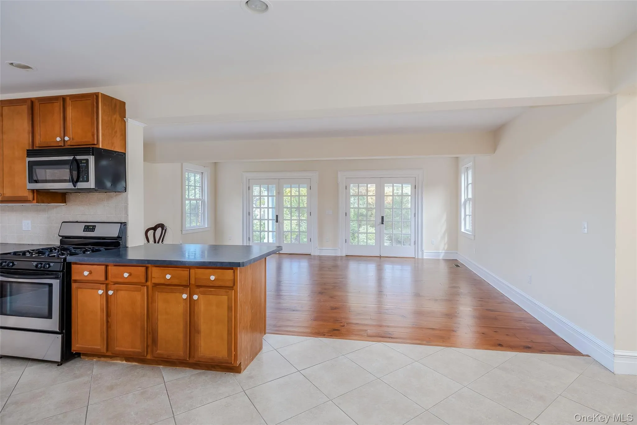 Family Room is off of the Kitchen with French doors leading to outdoor porch with views of the harbor. Family Room is off of the Kitchen with French doors leading to outdoor porch with views of the harbor.