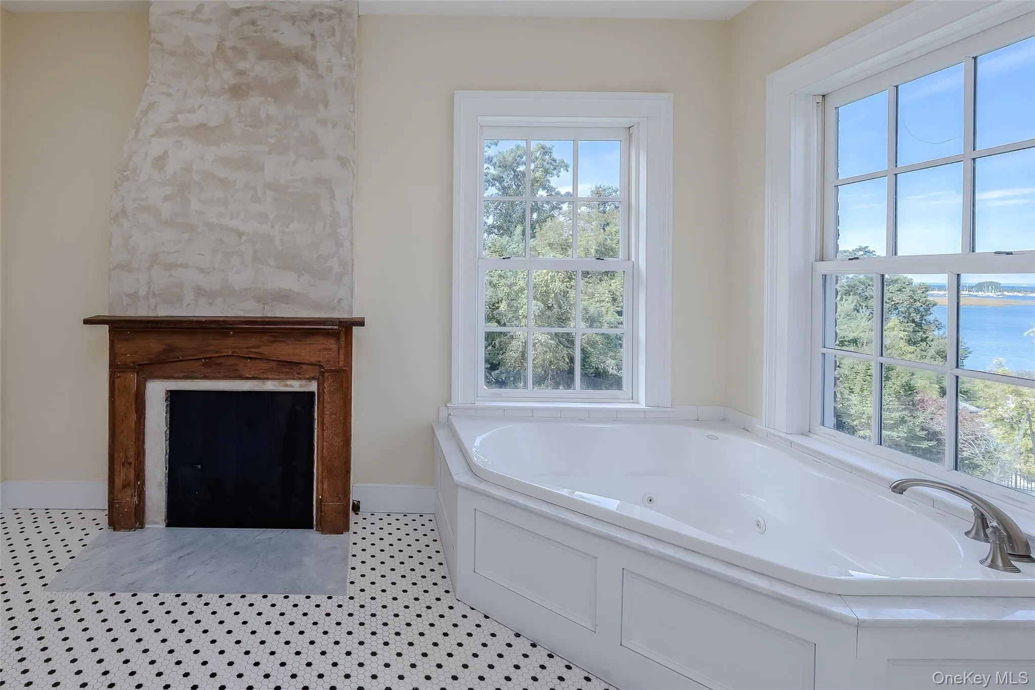Bathroom Featuring a Water View-Decorative Fireplace Bathroom Featuring a Water View-Decorative Fireplace