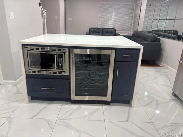 Kitchen Island feature a Wine refrigerator and draw like microwave. Kitchen Island feature a Wine refrigerator and draw like microwave.