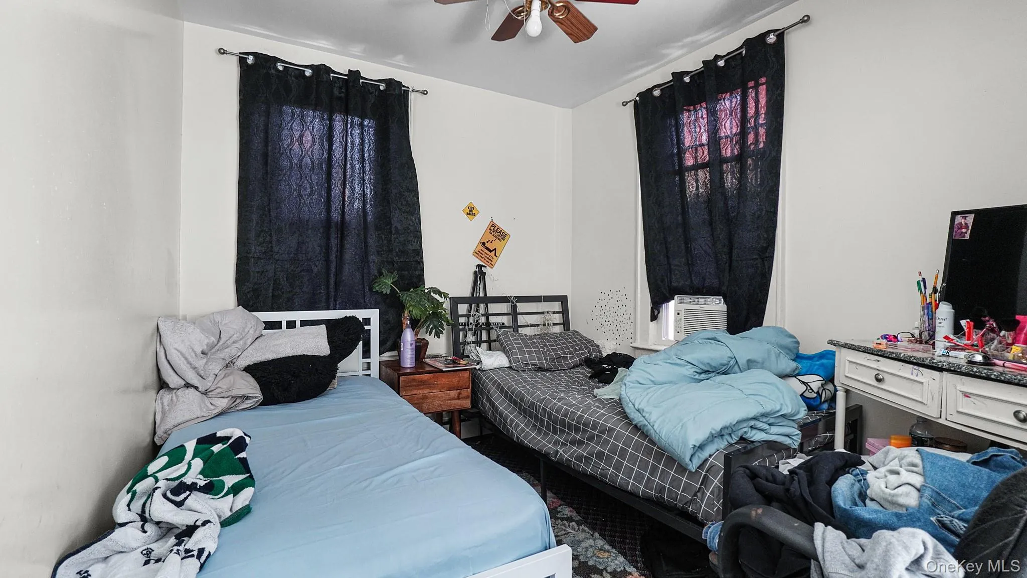 Dual windows with curtain rods and a ceiling-mounted light fixture Dual windows with curtain rods and a ceiling-mounted light fixture