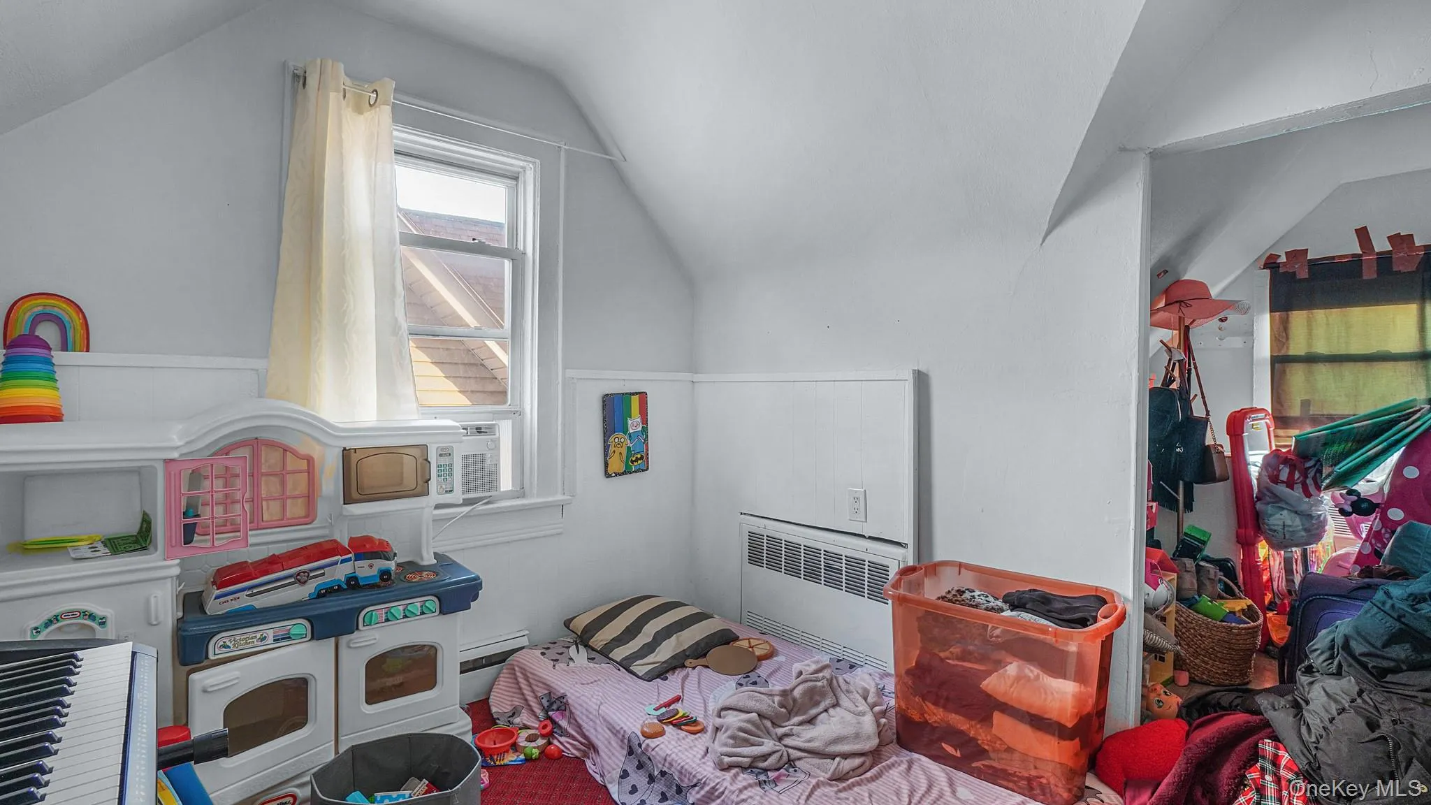 Vaulted ceiling, painted wall paneling, and a double-hung window Vaulted ceiling, painted wall paneling, and a double-hung window
