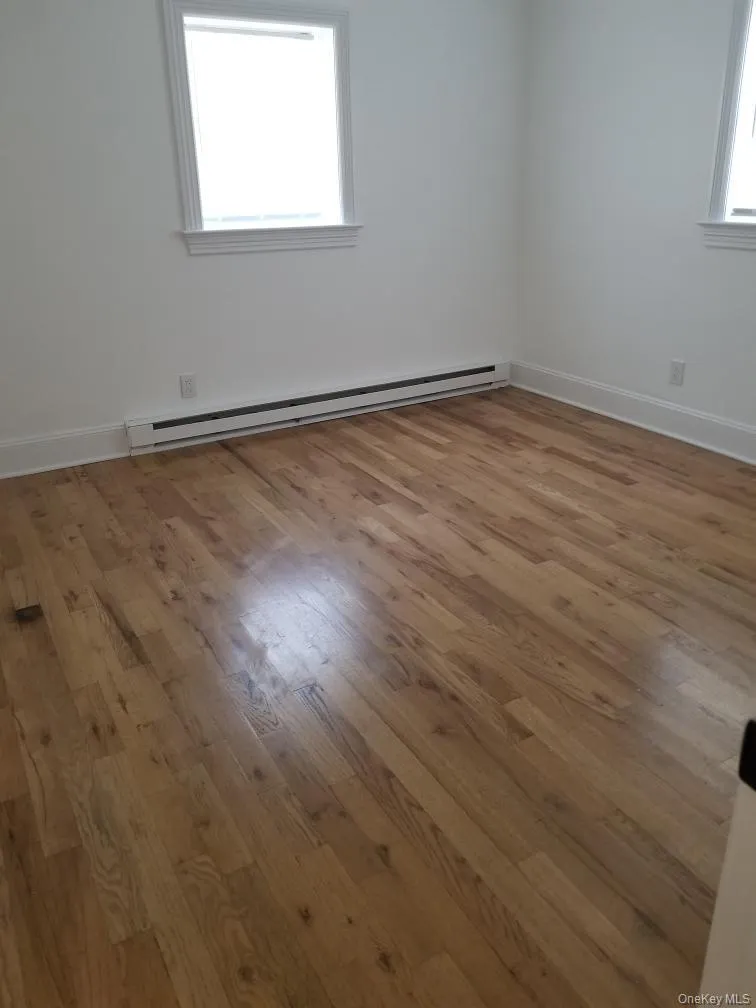 Hardwood flooring and dual windows with white trim Hardwood flooring and dual windows with white trim