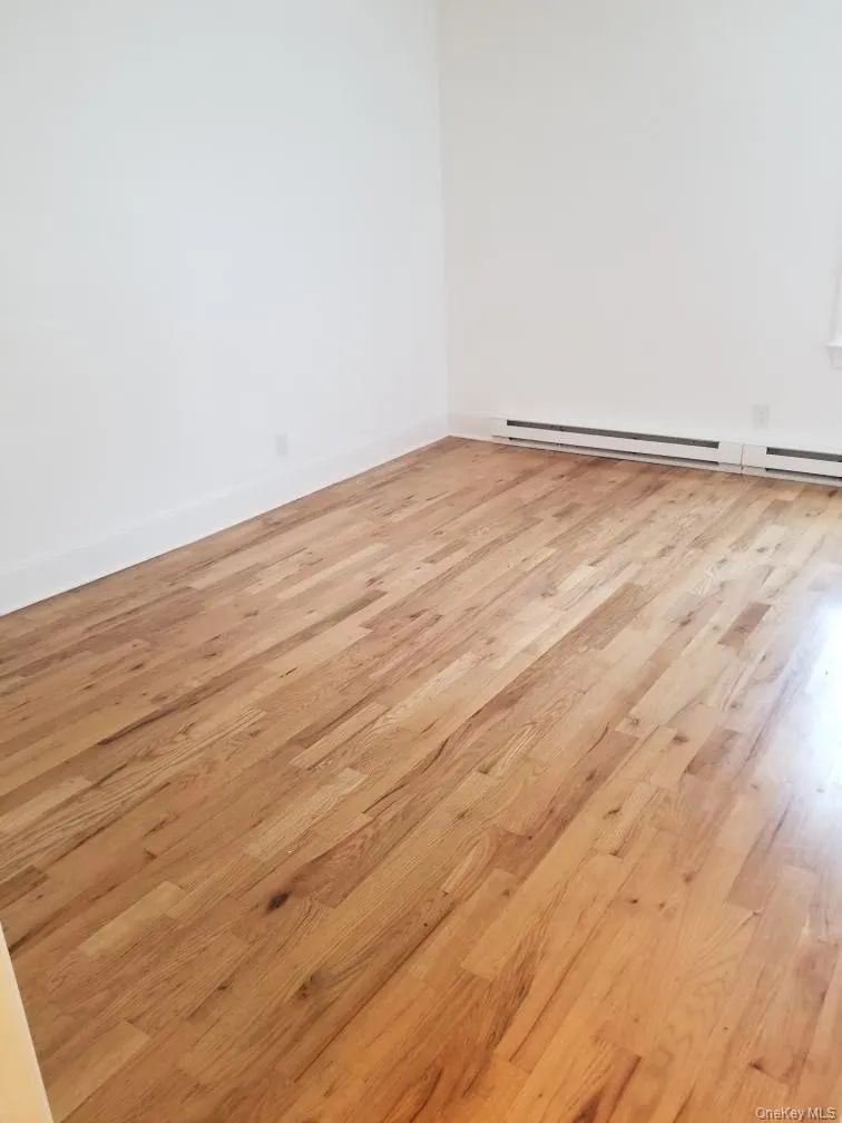 Interior space featuring light-toned wood-finish flooring and neutral wall paint Interior space featuring light-toned wood-finish flooring and neutral wall paint