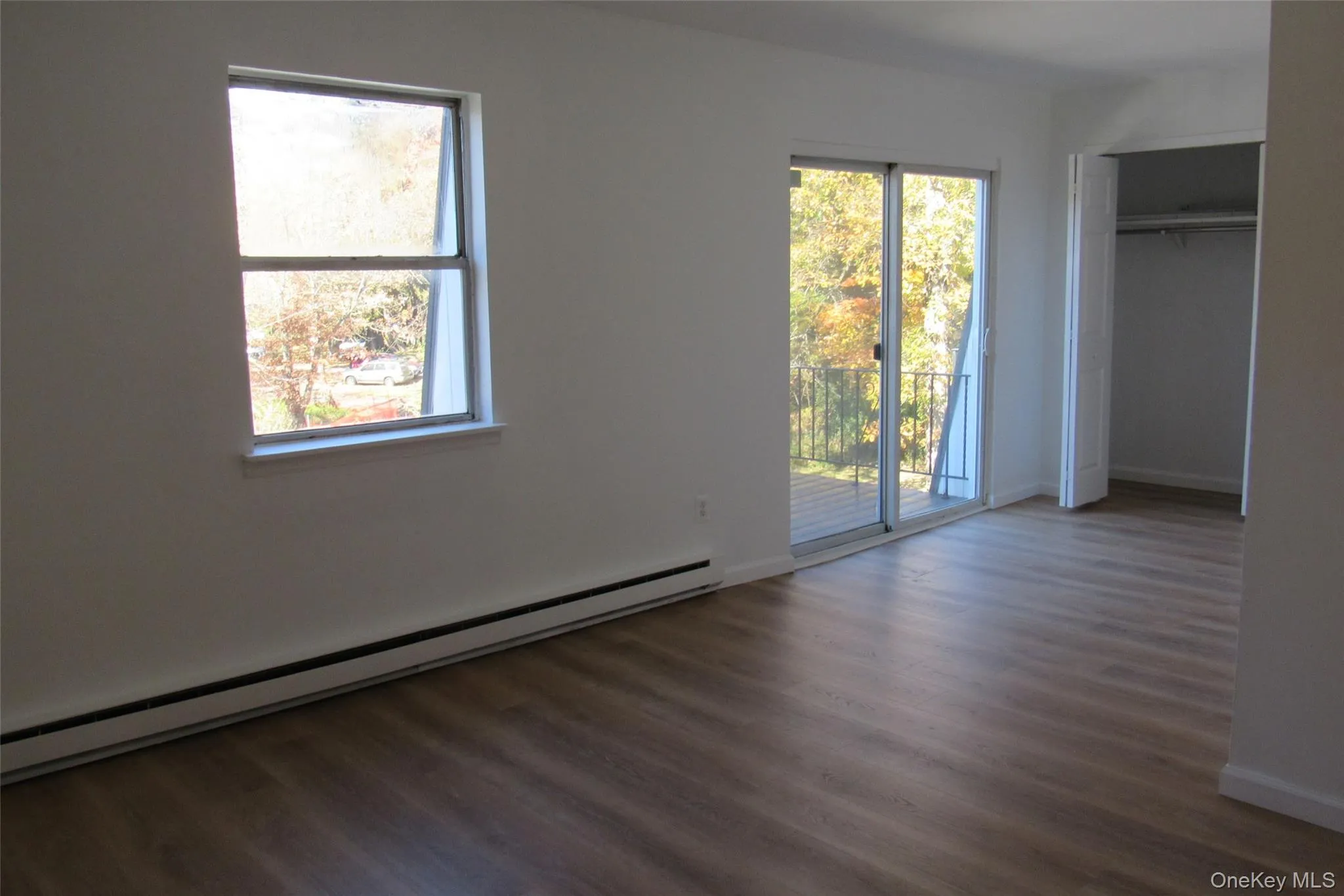 Wood-finish flooring, sliding glass door to balcony, double door closet Wood-finish flooring, sliding glass door to balcony, double door closet