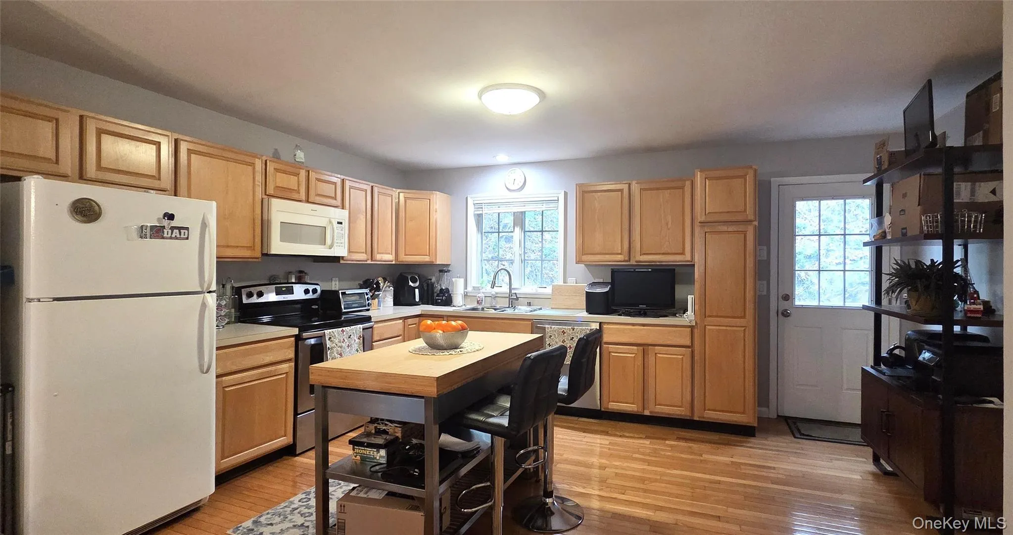 Kitchen has loads of cabinets, a pantry closet and door to the deck Kitchen has loads of cabinets, a pantry closet and door to the deck