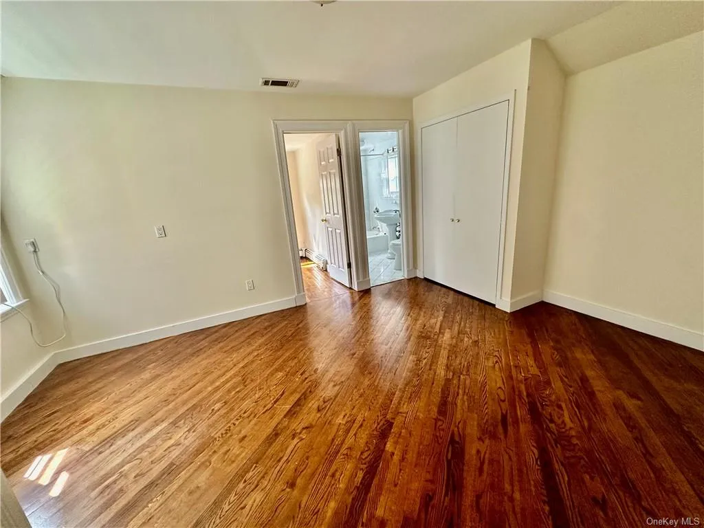 Unfurnished entry room to upstairs that can be used as a bedroom with closet, office or sitting room - access to full bathroom with additional 2 bedrooms one on each side, and wood-type flooring Unfurnished entry room to upstairs that can be used as a bedroom with closet, office or sitting room - access to full bathroom with additional 2 bedrooms one on each side, and wood-type flooring