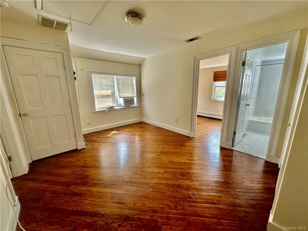 Unfurnished entry room to upstairs that can be used as a bedroom with closet, office or sitting room - access to full bathroom with additional 2 bedrooms one on each side, and wood-type flooring Unfurnished entry room to upstairs that can be used as a bedroom with closet, office or sitting room - access to full bathroom with additional 2 bedrooms one on each side, and wood-type flooring