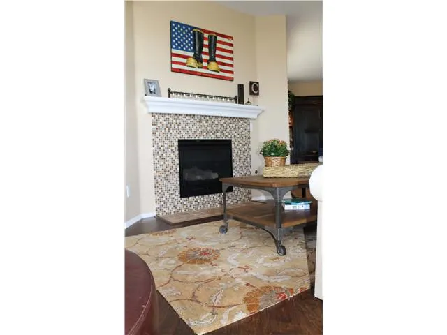 The fireplace is an added plus in the Alcea community.  This one includes a glass-tile surround.