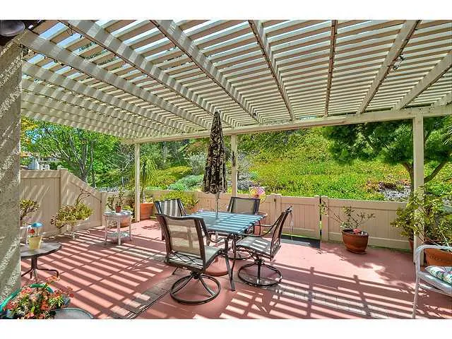 Rear patio overlooks peaceful greenbelt