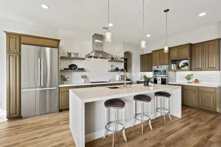 Expansive kitchen with vaulted ceiling, new cabinets, Dacor Appliances, Ceasar Stone w/waterfall