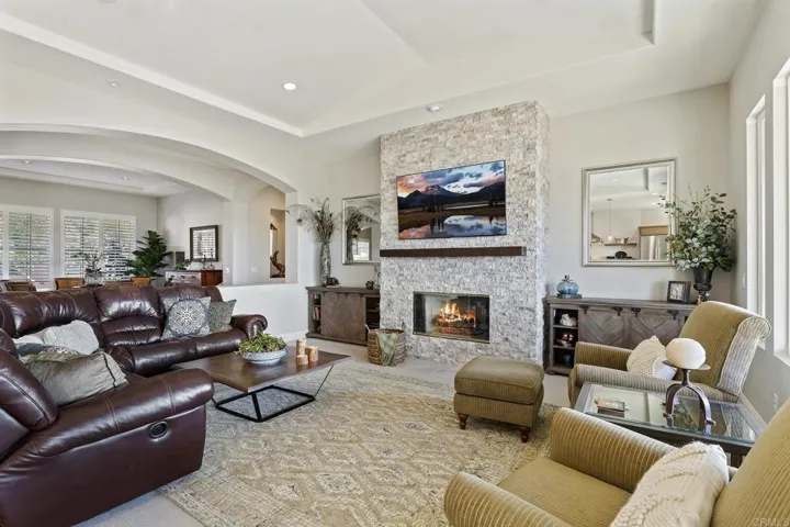 New fireplace facade with video channeling and connector box. Vaulted ceiling, new recessed lighting