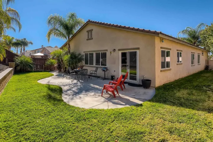 Relax in the cool breeze in this nice manicured back yard.
