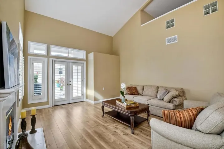 Bright and airy living room. Plantation shutters on the window. Living Room measures 18 x 14.