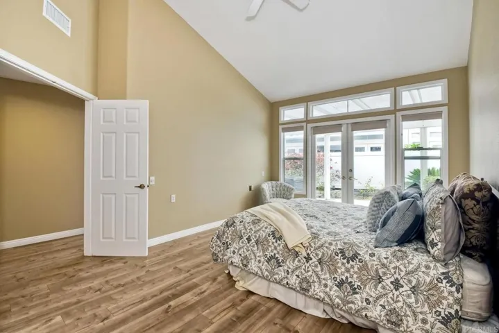 Light filled Master Bedroom with double entry doors and door to patio.