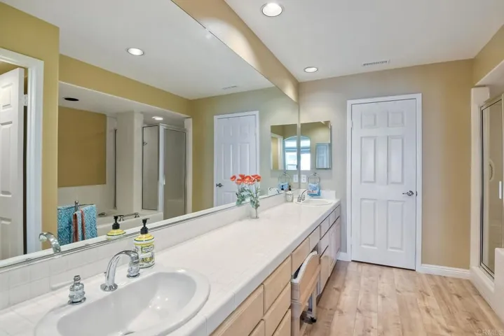 Master bathroom with dual sinks, shower and soaking tub.