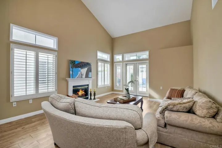 Living Room with gas fireplace and French Doors to large back patio.