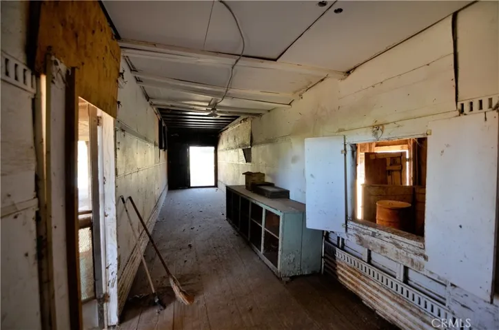 Interior of animal barn. Used previously for food and hay storage for sheep, pigs, and more