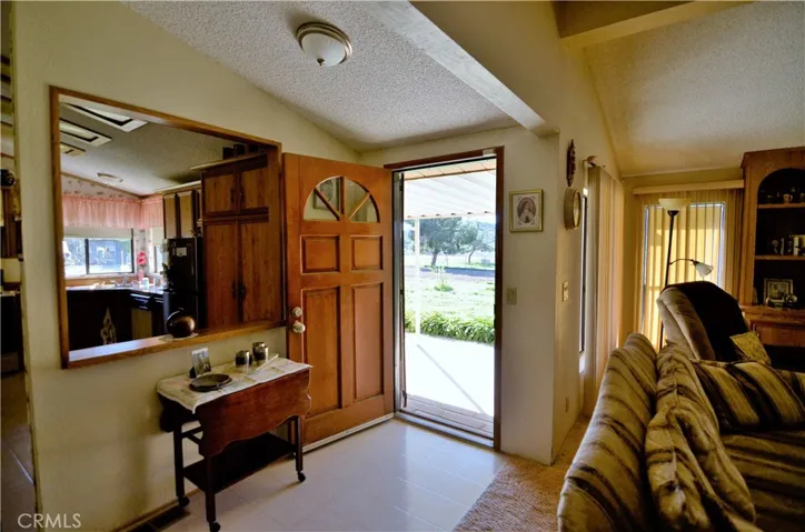 Front Door View from Living Room with Pass Through to Kitchen