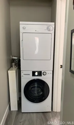 Stack washer and dryer in located off hallway.