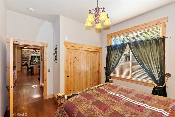 Downstairs Bedroom with Wood Door Closet and Entry
