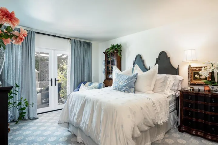 This is the 2nd master bedroom. Walk-in closet. French doors lead to the outdoor fireplace & views.