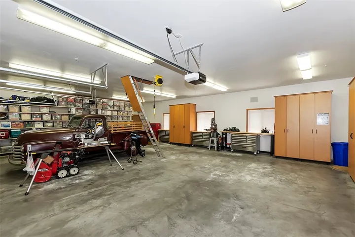 4 Car Garage w/ Attic Storage above.
Welding outlet, Electric Cord roller, and Air compressor hose reel.