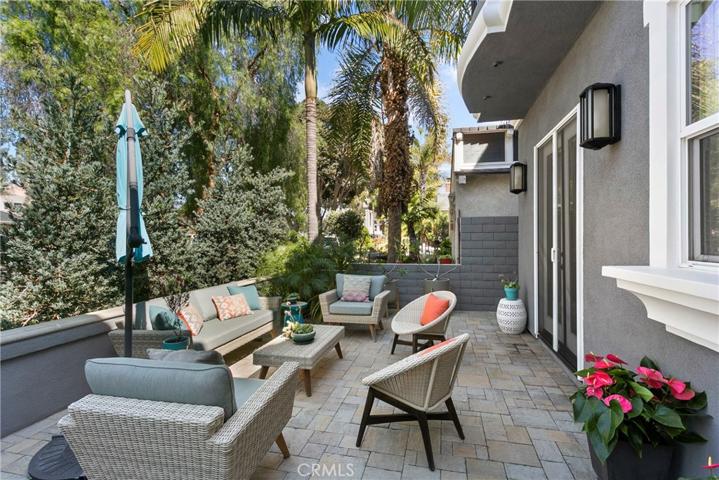 Quality continues outdoors too...this beautiful front patio has gorgeous pavers, stone capped walls and is the perfect place to enjoy our Orange Coast climate!