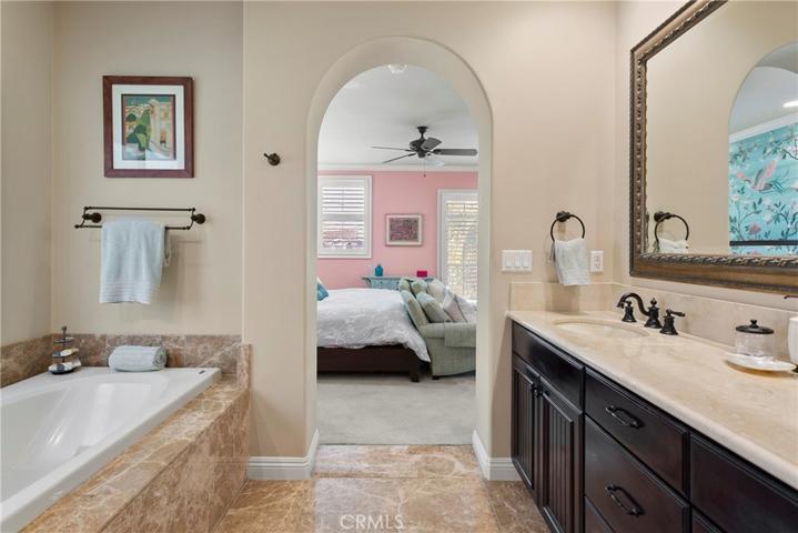 All hardware and fixtures throughout have rich bronze finish.  Custom framed mirrors add the designer touch.