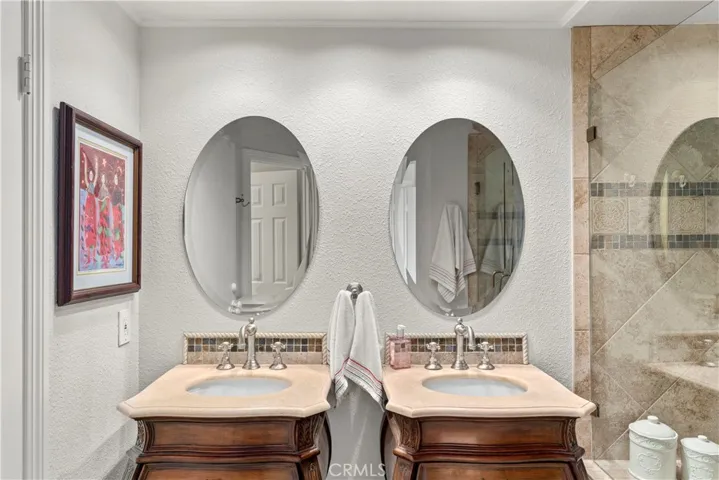 Dual Vanities with ROHL fAUCETS, Walk-In Shower with a seat, walk-in closet.
